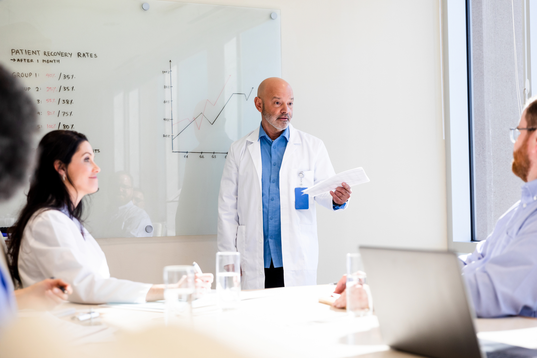 The mature male doctor speaks in a meeting room